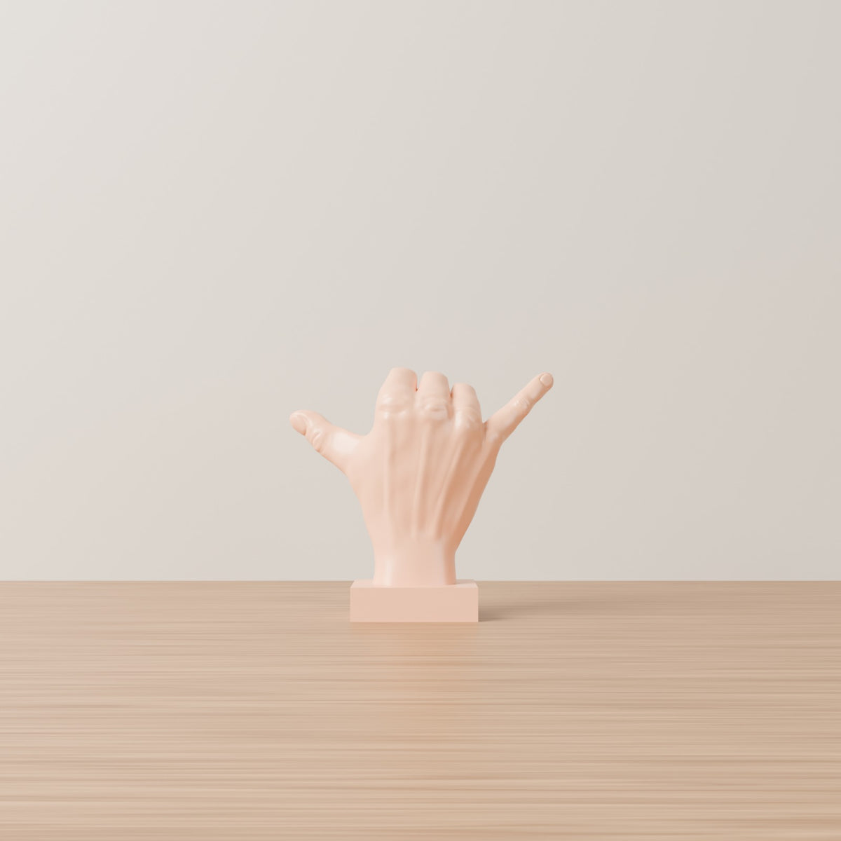 Shaka hand desk sculpture peach on wooden table plain